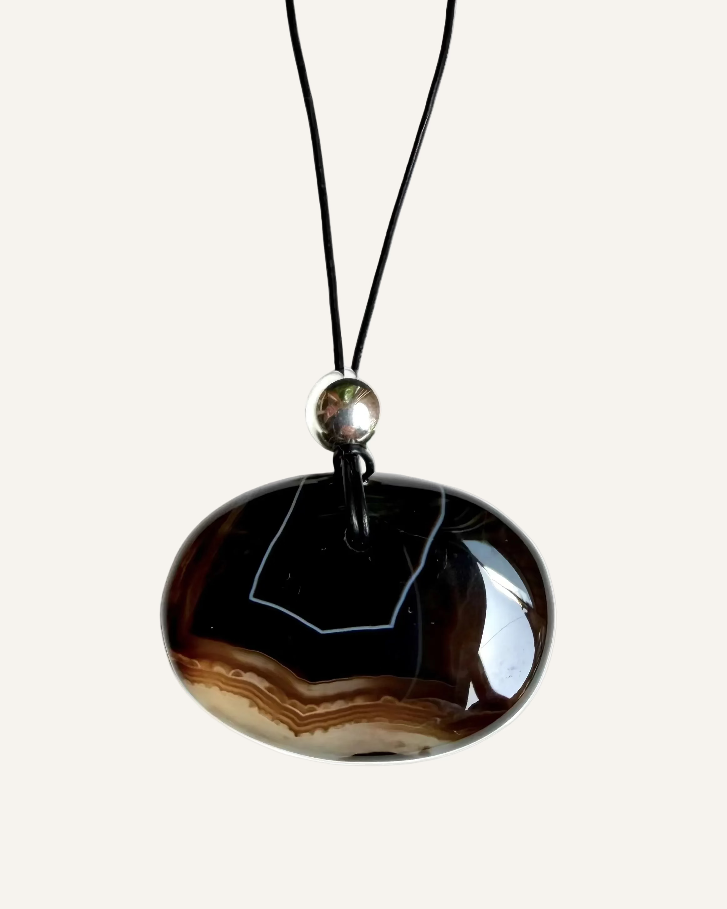 Black cord gemstone pendant necklace on a white background