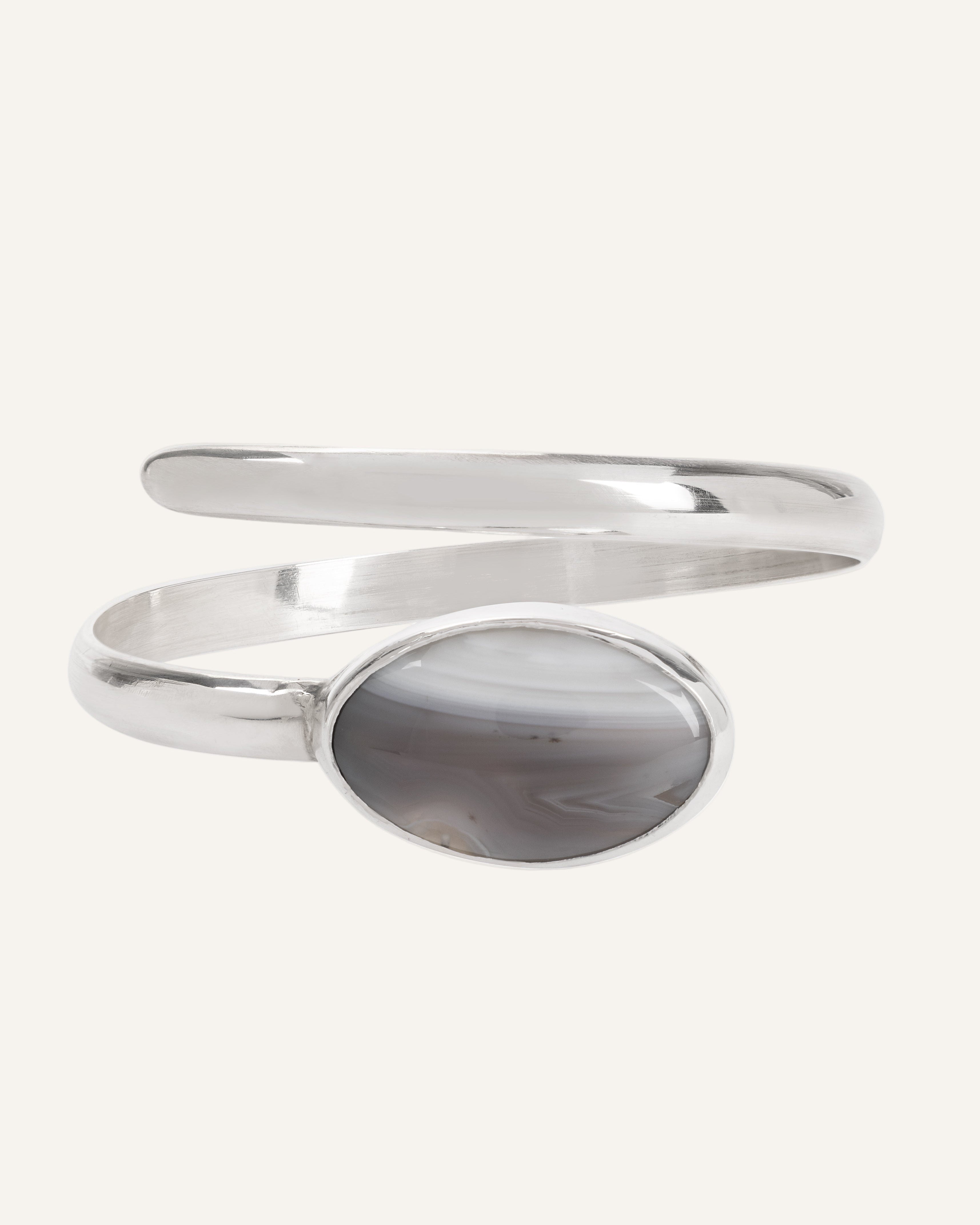 Silver bangle with agate stone on a white background